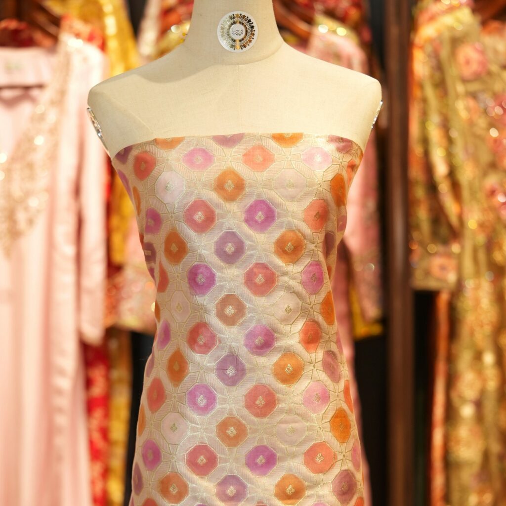 Katan silk fabric with octagonal Zari weaving and multicolor rangkaat dye in pink, orange, and lavender
