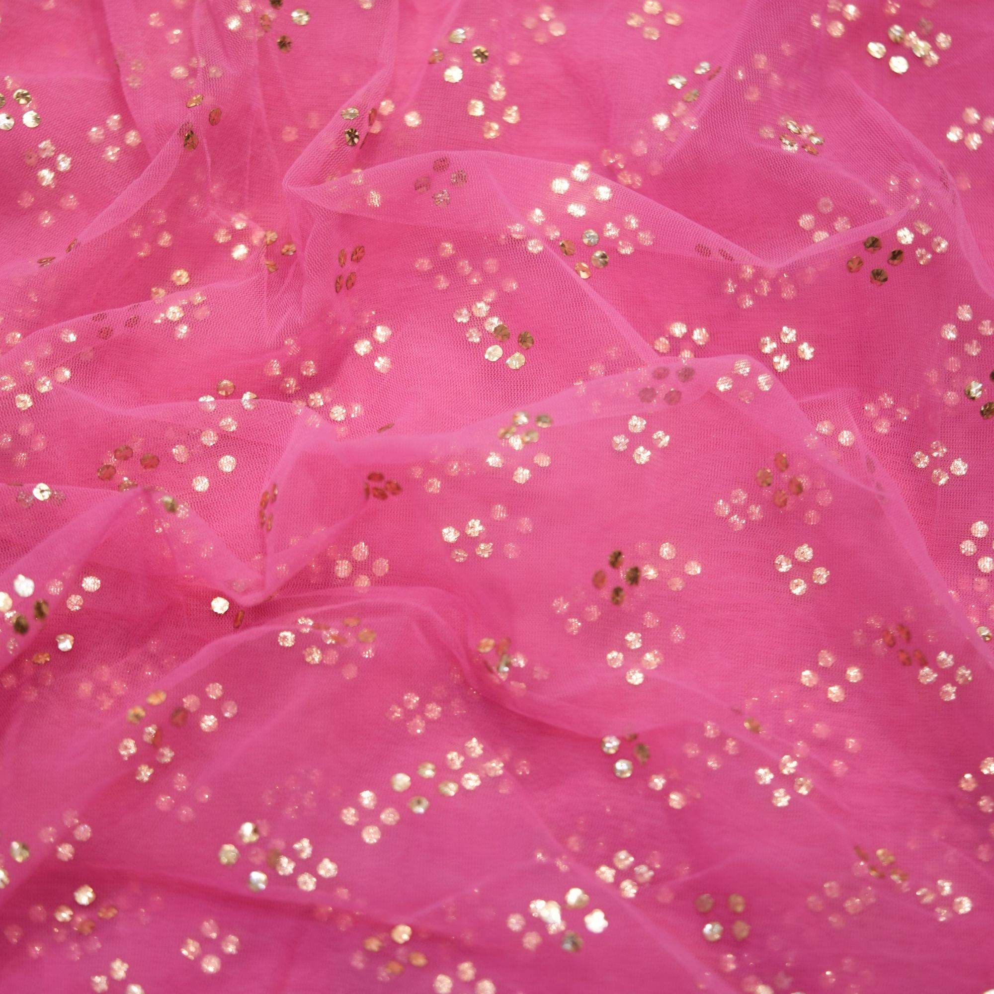 Pink net fabric with shimmering cascading Mukaish floral dots
