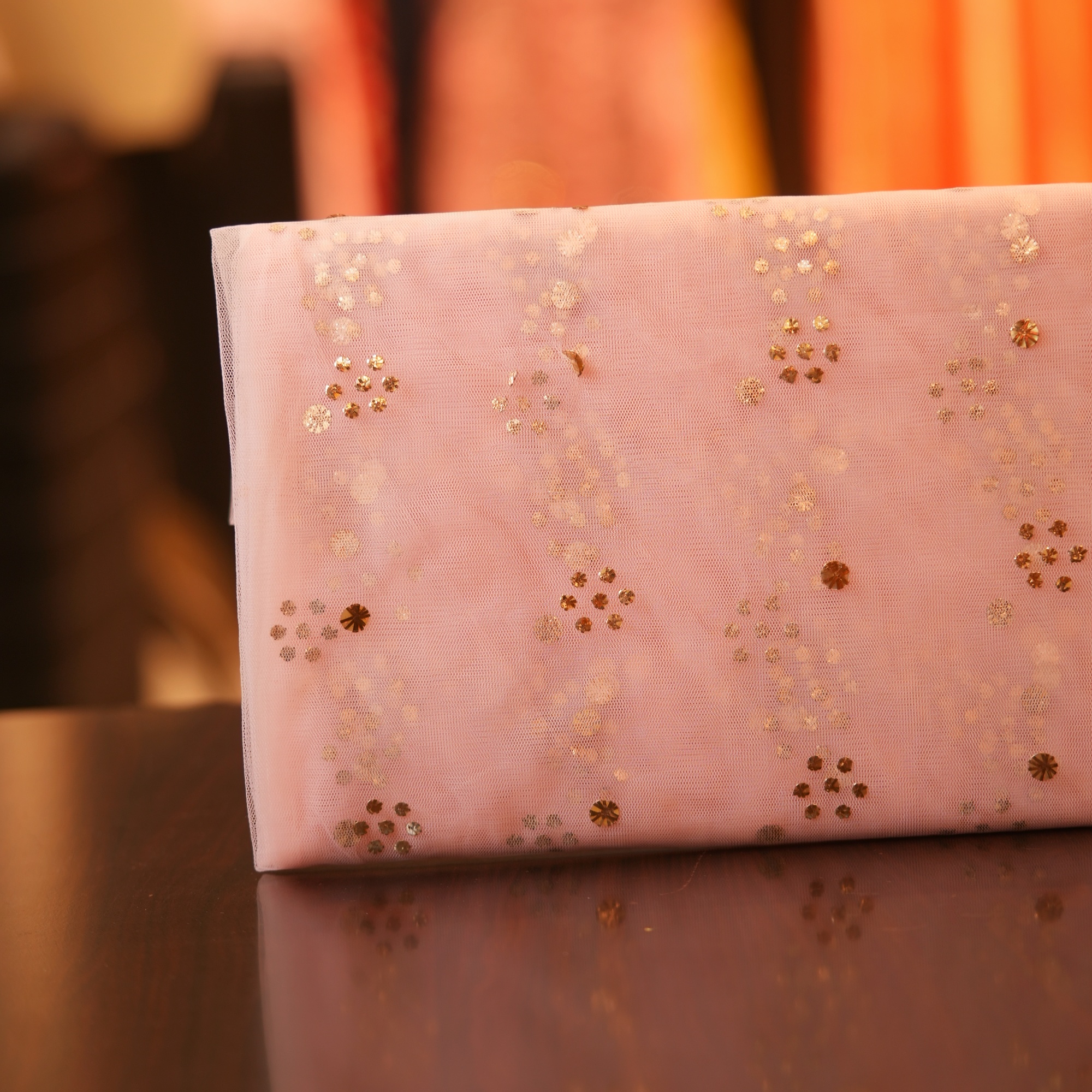 Blush pink net fabric with golden and silver Mukaish floral foil pattern