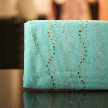 Aqua blue net fabric with Mukaish wave-line pattern in gold and silver dots