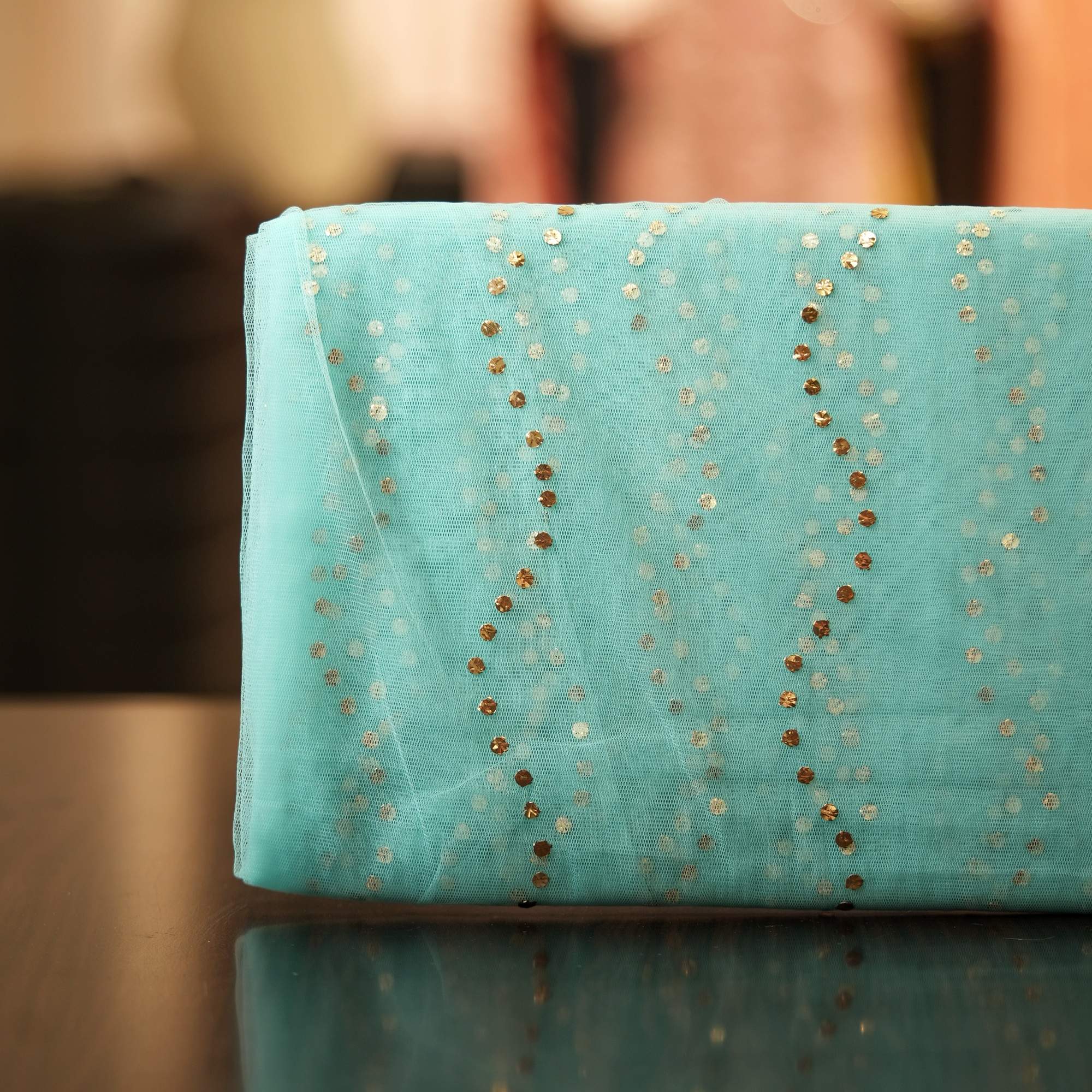 Aqua blue net fabric with Mukaish wave-line pattern in gold and silver dots