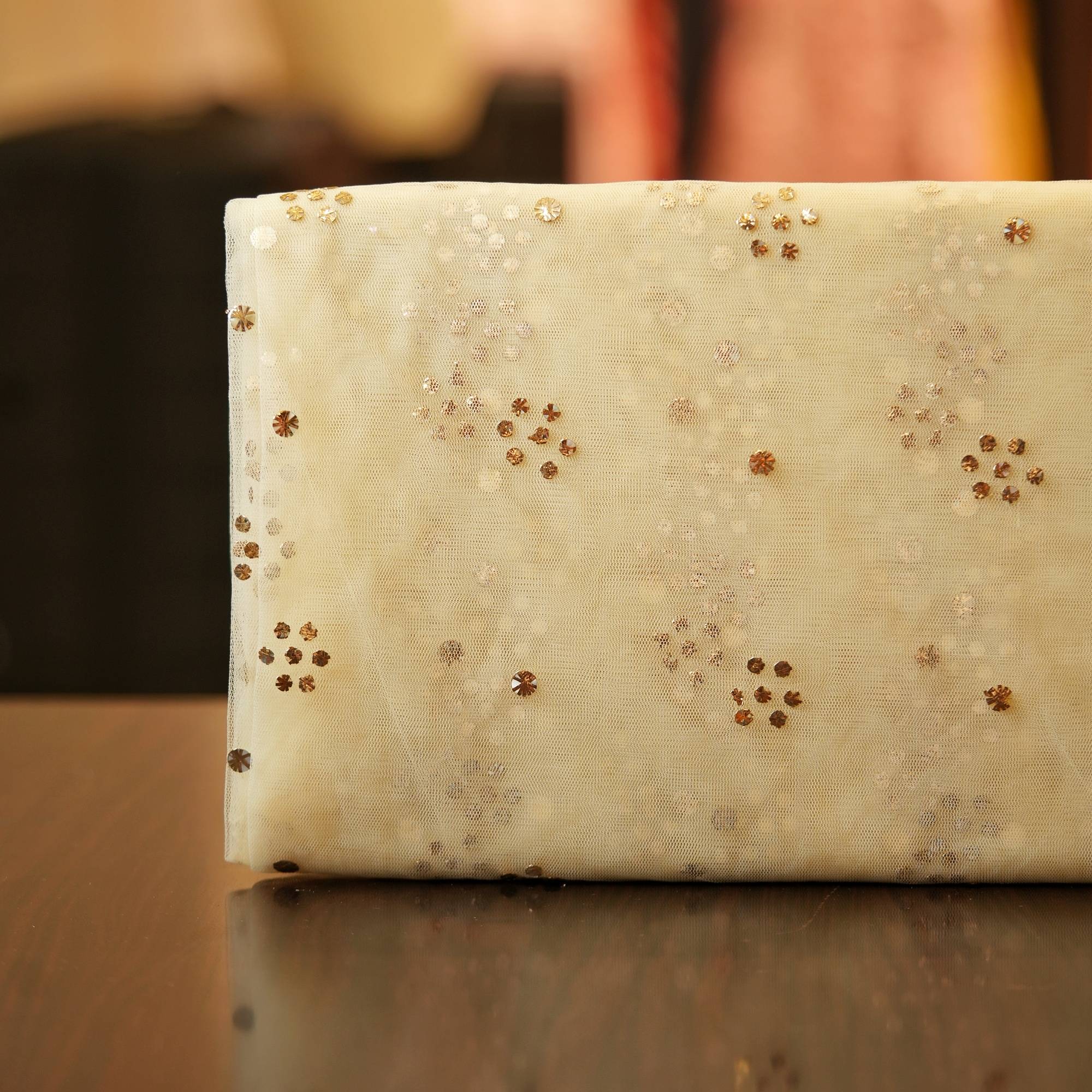 Ivory beige net fabric with floral Mukaish dot clusters in gold and silver