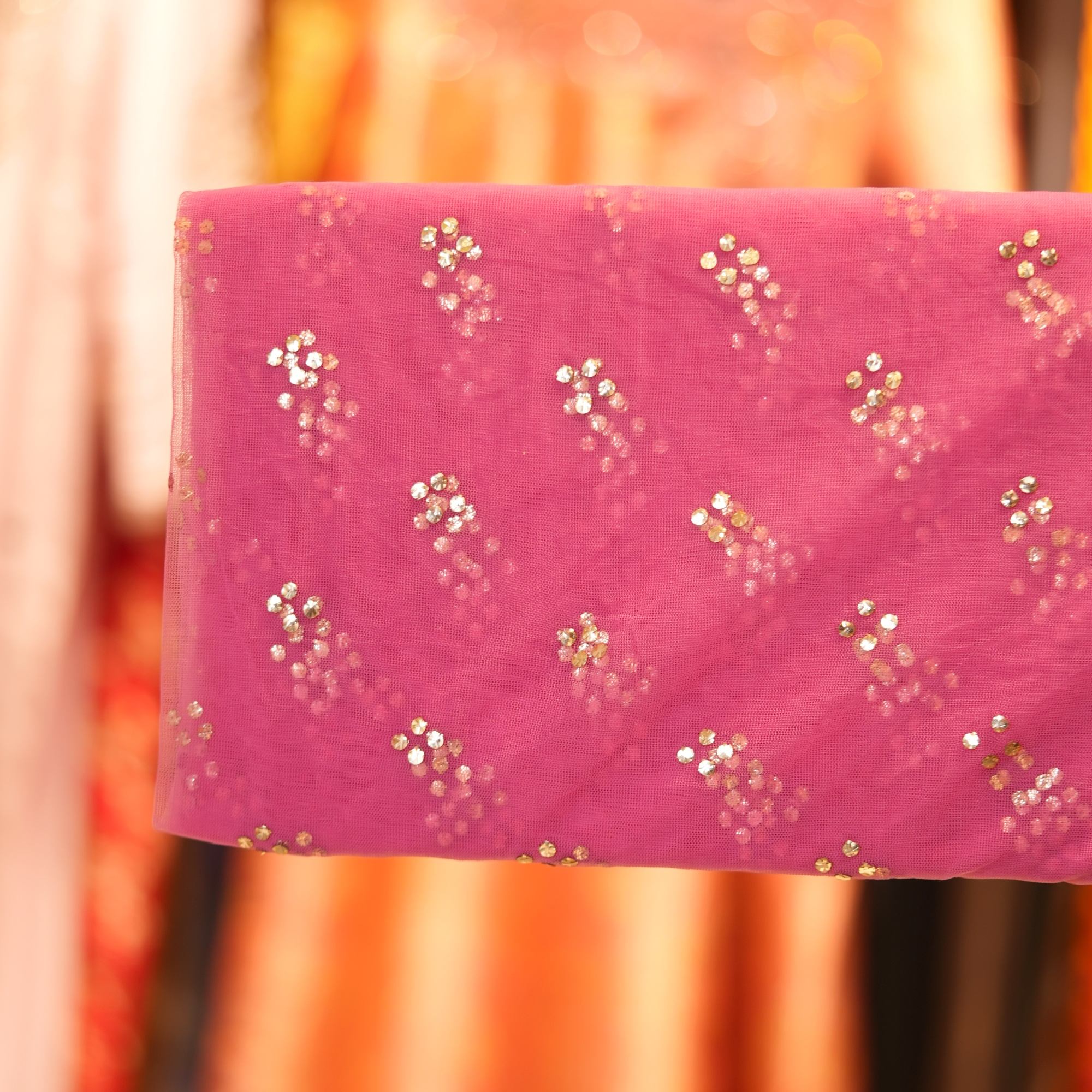 Pink net fabric with shimmering cascading Mukaish floral dots