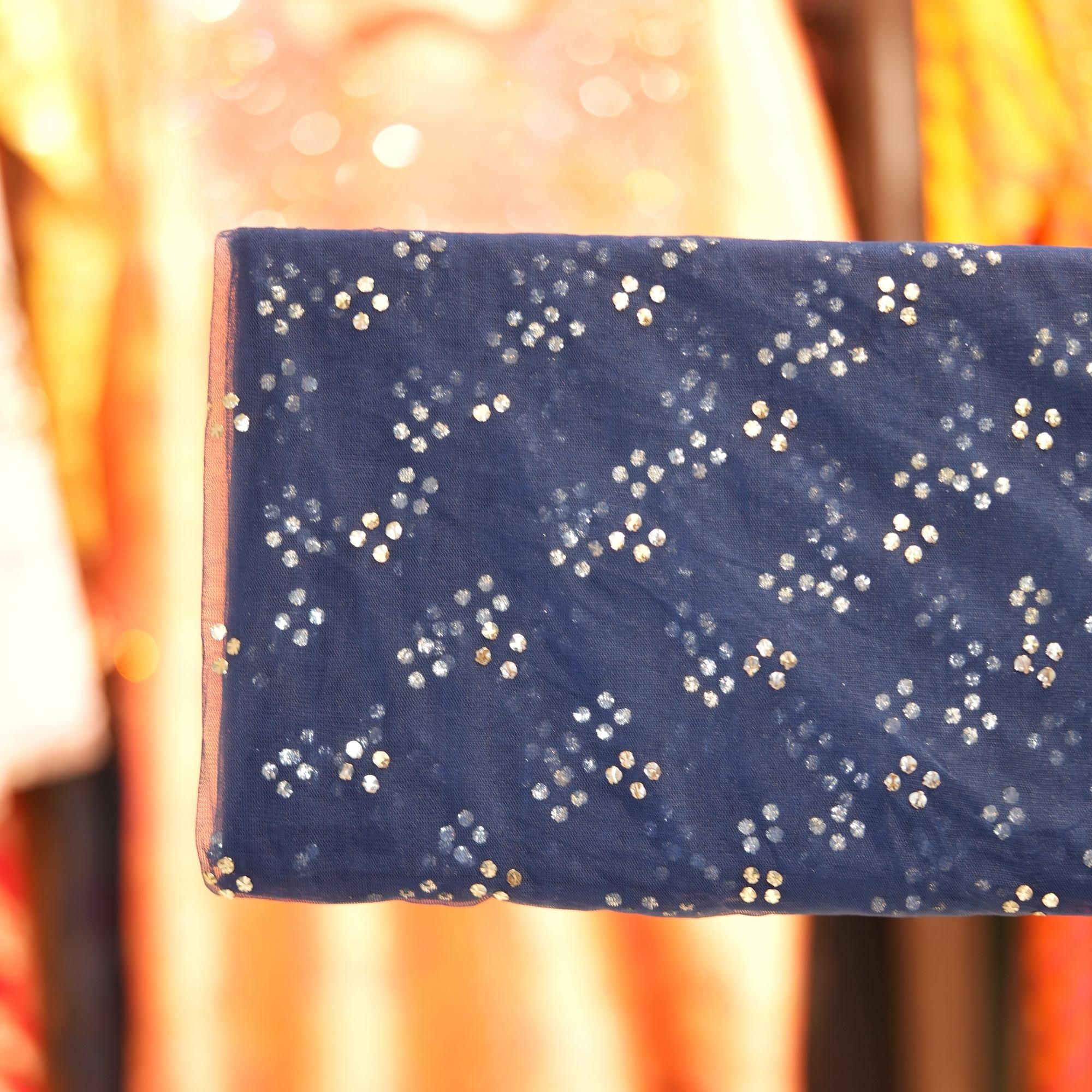 Navy blue net fabric with hand Mukaish foil work in diagonal clustered pattern