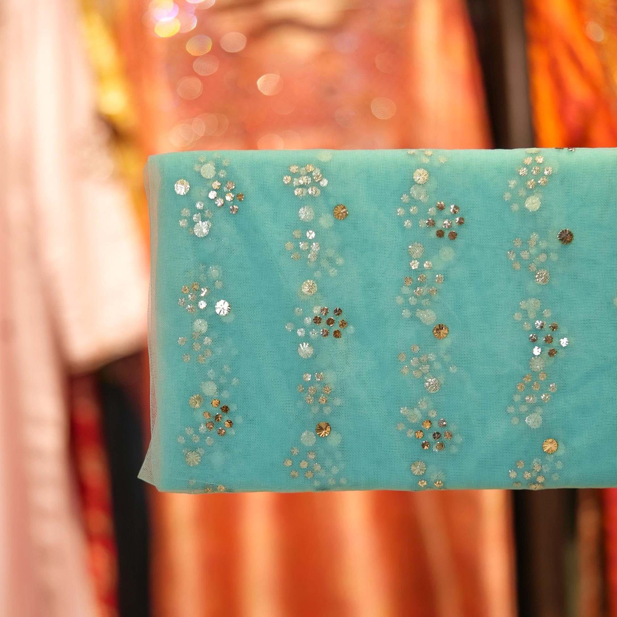 Turquoise net fabric with floral Mukaish foil work in cascading dotted vines