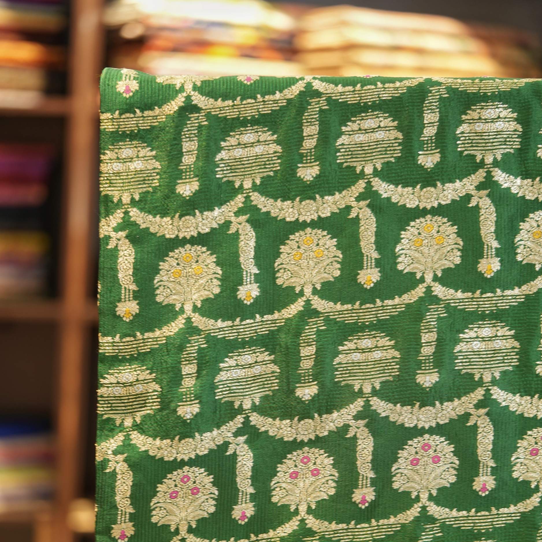 Green pure Katan silk fabric with golden zari and colorful meenakari floral motifs