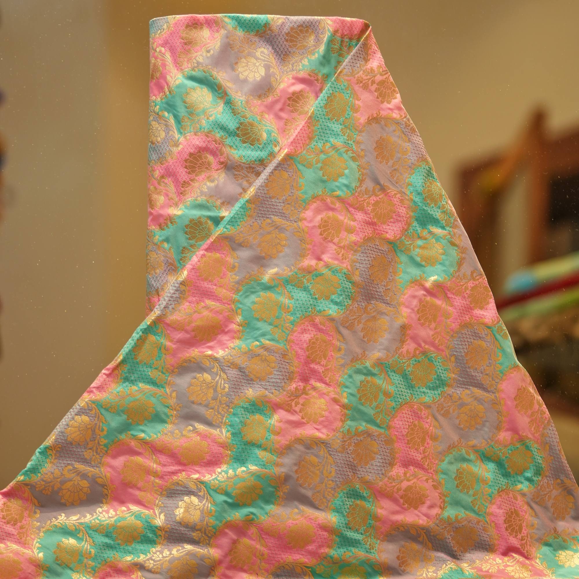 Multicolor Indian silk fabric with circular rangkaat dyeing and intricate golden zari weaving