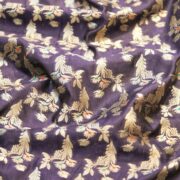 A refined navy blue dupion silk adorned with silver zari florals and subtle pops of meena work — perfect for contemporary thobes, statement pieces, or couture accents.