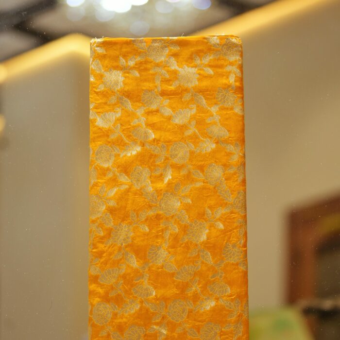 Golden yellow dupion silk fabric with intricate zari floral weave