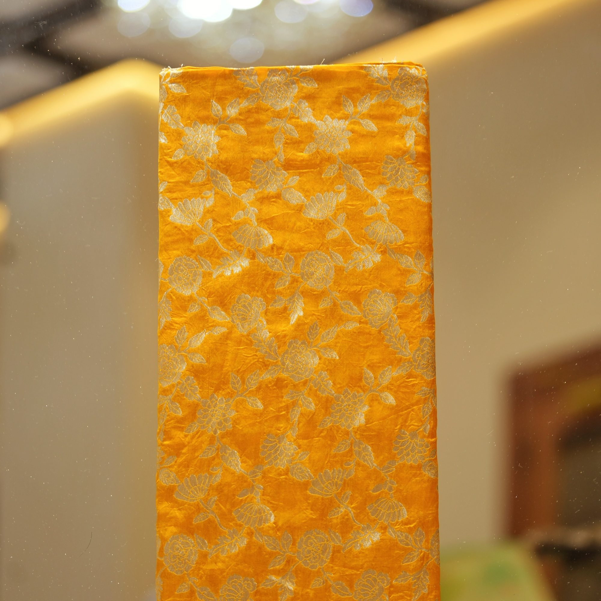 Golden yellow dupion silk fabric with intricate zari floral weave