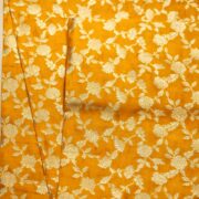 Golden yellow dupion silk fabric with intricate zari floral weave