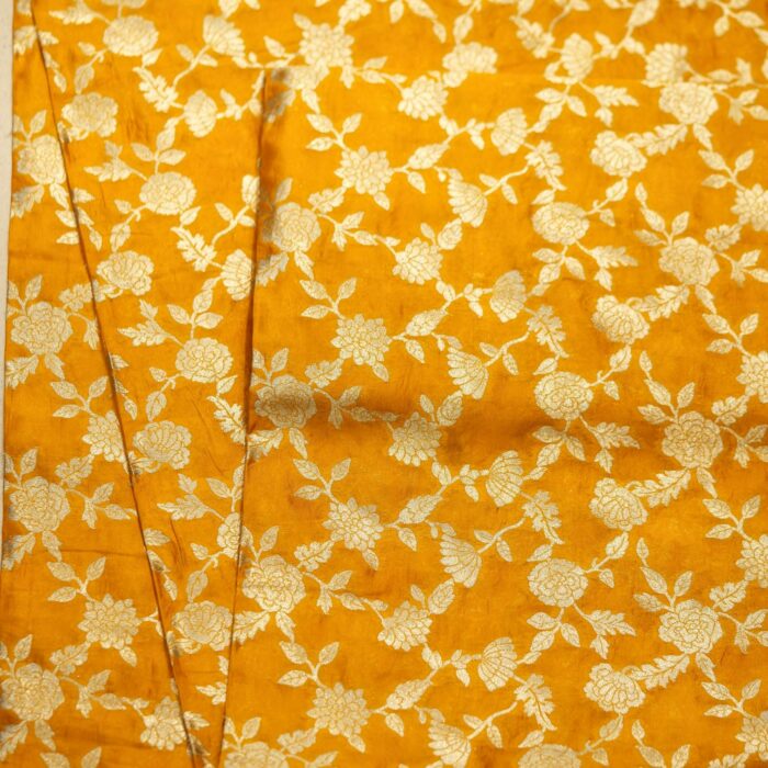 Golden yellow dupion silk fabric with intricate zari floral weave