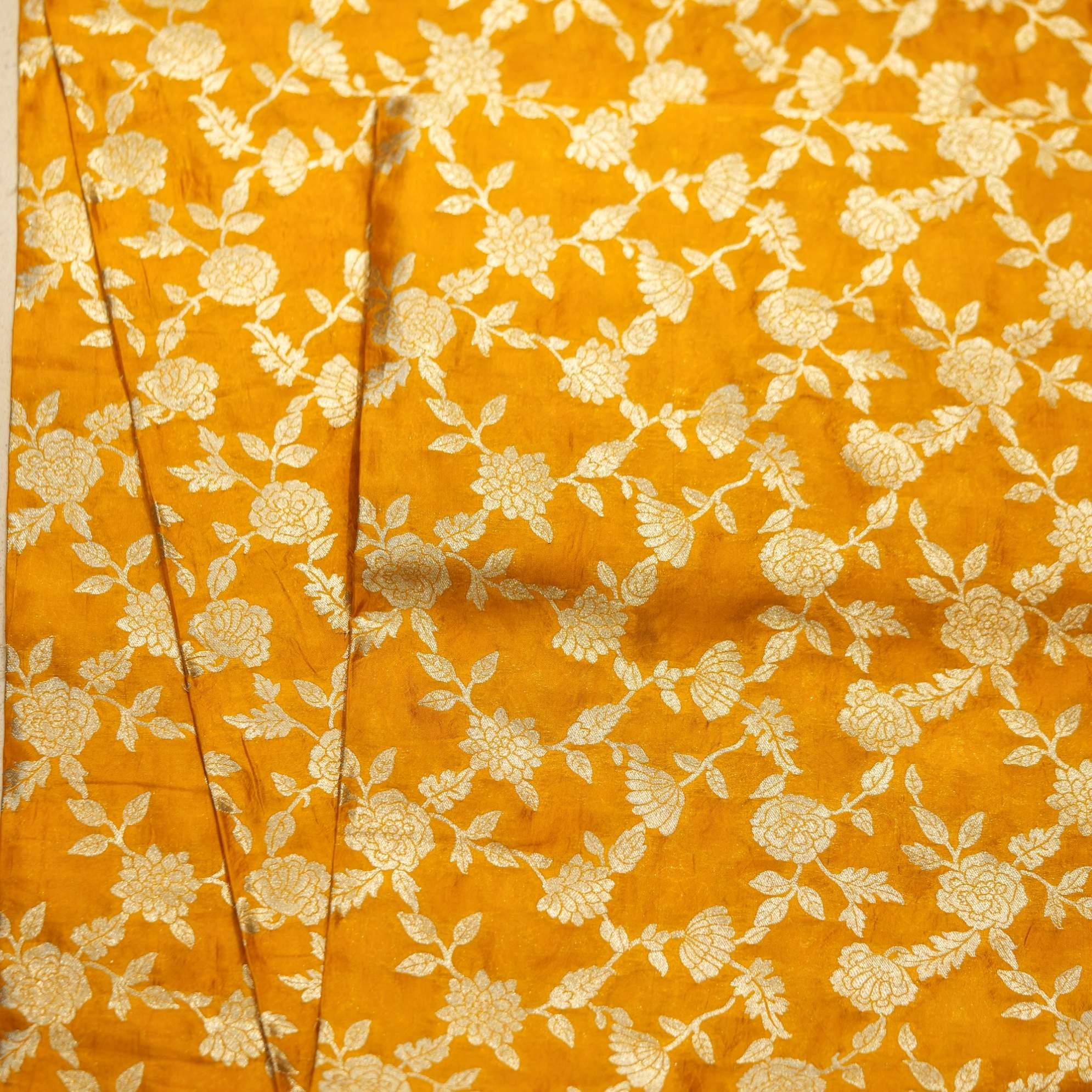 Golden yellow dupion silk fabric with intricate zari floral weave