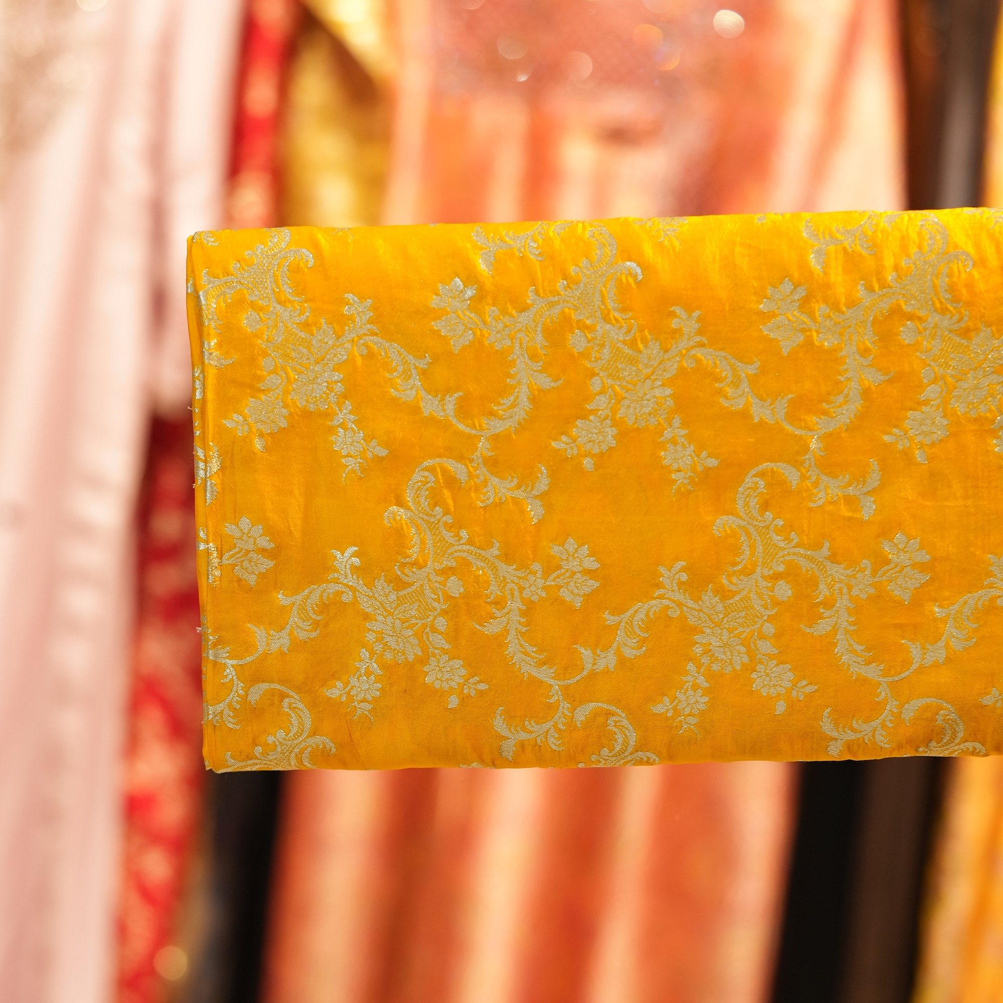 Bright yellow dupion silk fabric with light gold floral vine zari weaving