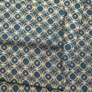 Teal dupion silk fabric woven with silver-gold Zari lattice circles and tiny red & yellow Meenakari accents – Zahiri collection