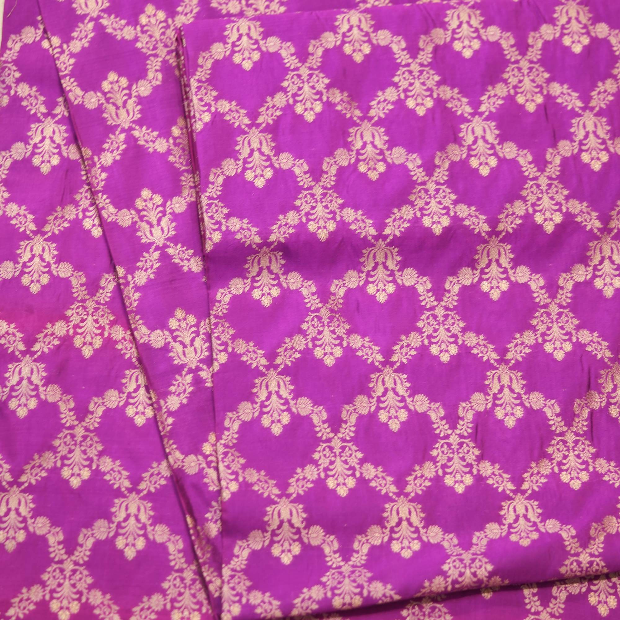 Fuchsia pink dupion silk fabric with light gold Zari chandelier-style floral weaving