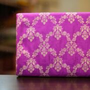 Fuchsia pink dupion silk fabric with light gold Zari chandelier-style floral weaving