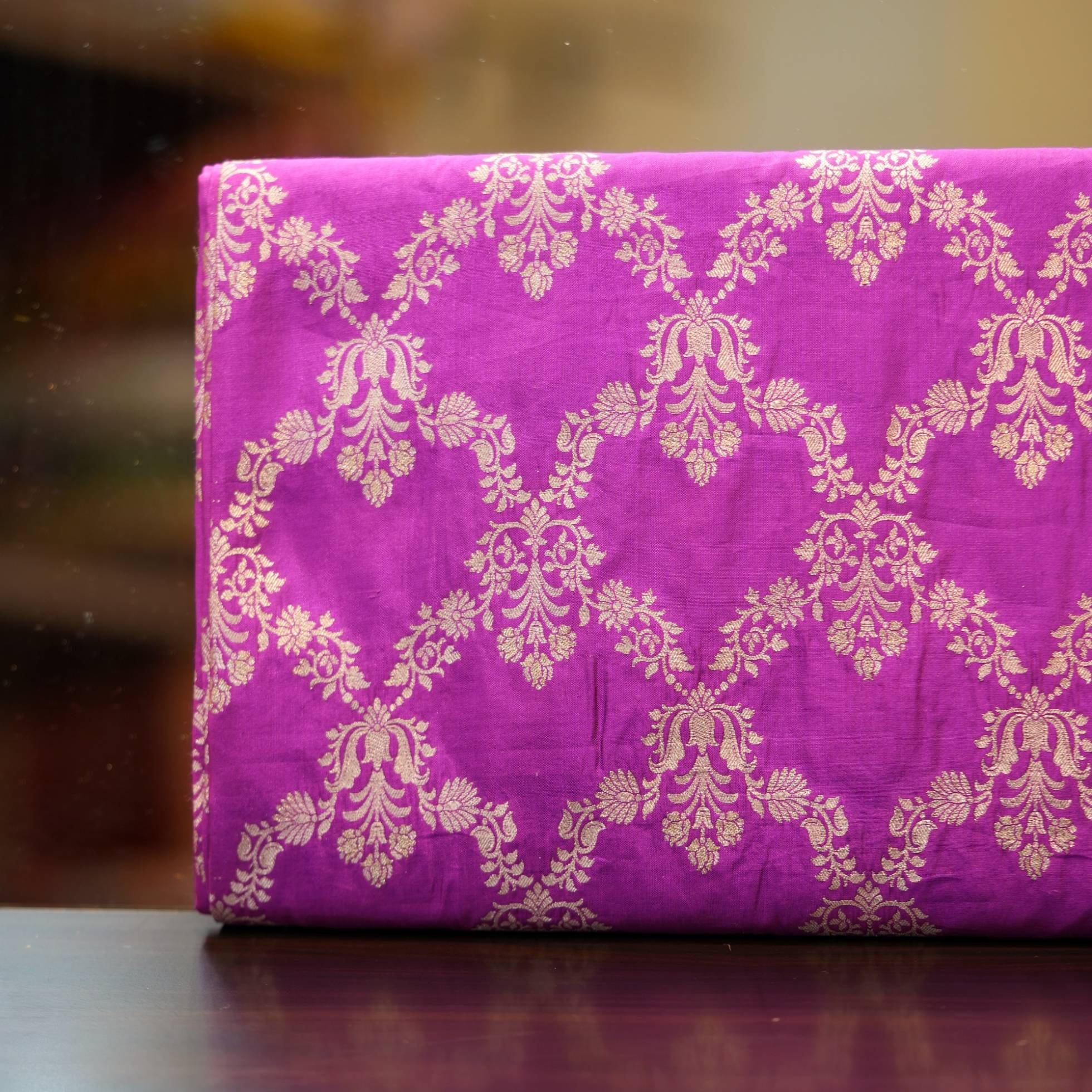 Fuchsia pink dupion silk fabric with light gold Zari chandelier-style floral weaving