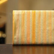 Golden-orange Rangkaat silk fabric with fine Zari stripe jaal design