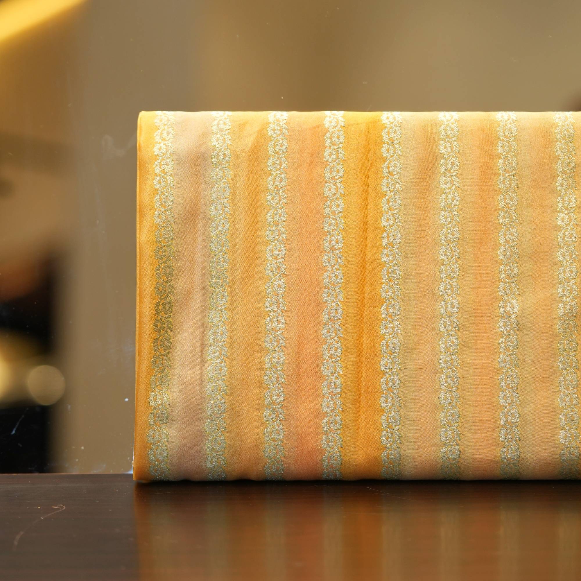 Golden-orange Rangkaat silk fabric with fine Zari stripe jaal design
