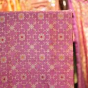 Rose pink silk fabric with golden Mughal jaal and floral Meena motifs