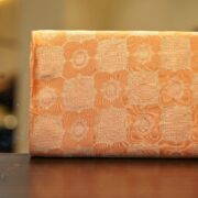 Pure royal silk fabric in peach with golden geometric textured Zari jaal weaving – Sundoori Zari Silk