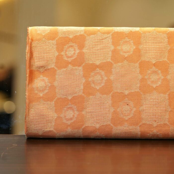 Pure royal silk fabric in peach with golden geometric textured Zari jaal weaving – Sundoori Zari Silk