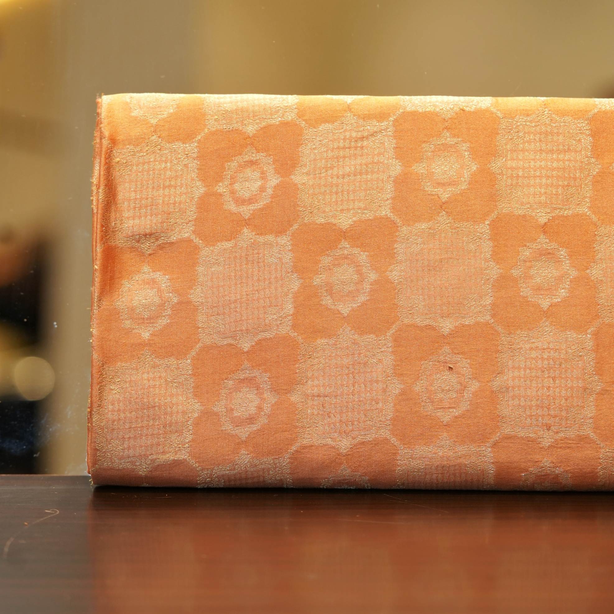 Pure royal silk fabric in peach with golden geometric textured Zari jaal weaving – Sundoori Zari Silk