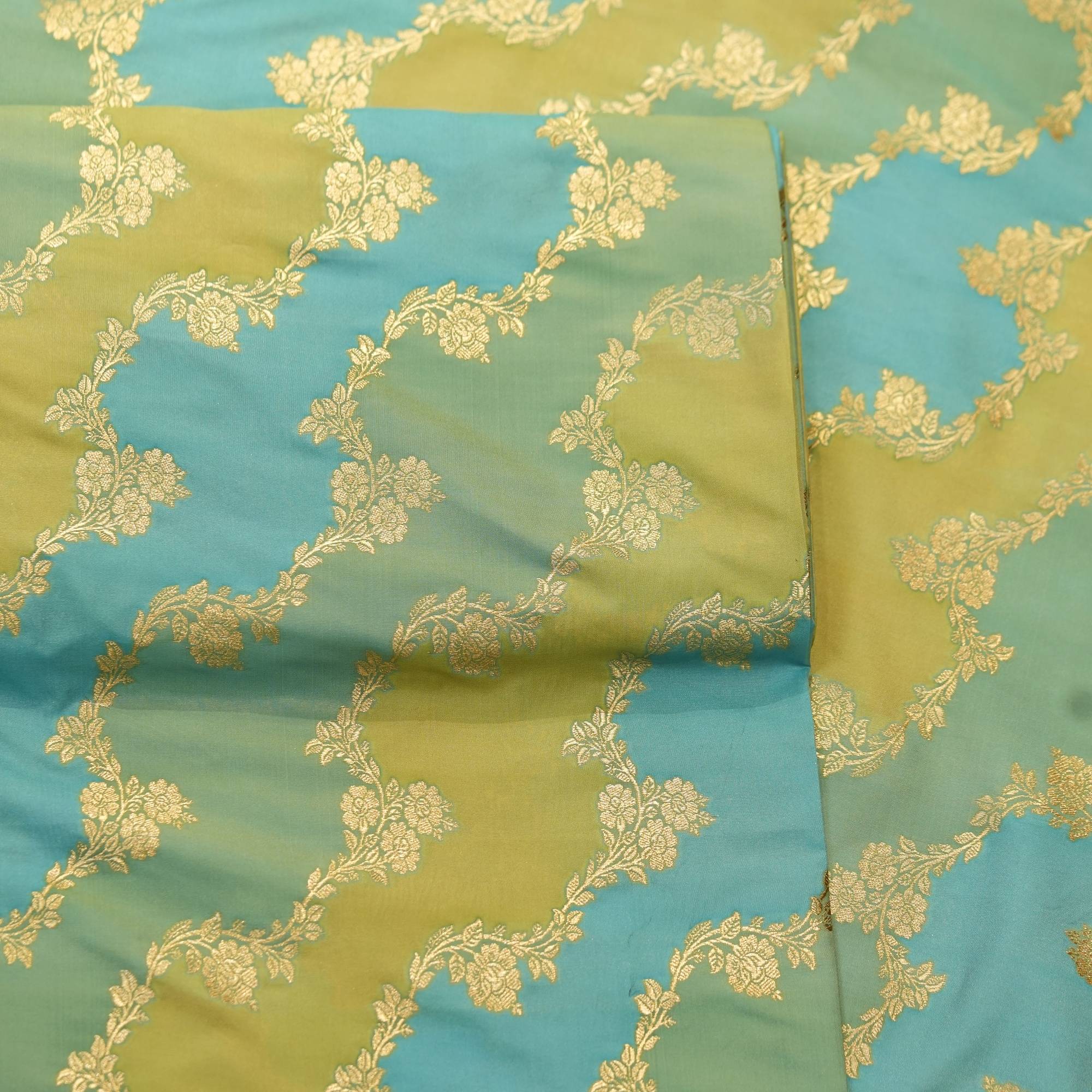 Indian hand-dyed Rangkaat silk fabric in green and aqua with golden Zari floral jaal – Bahaar-e-Rang