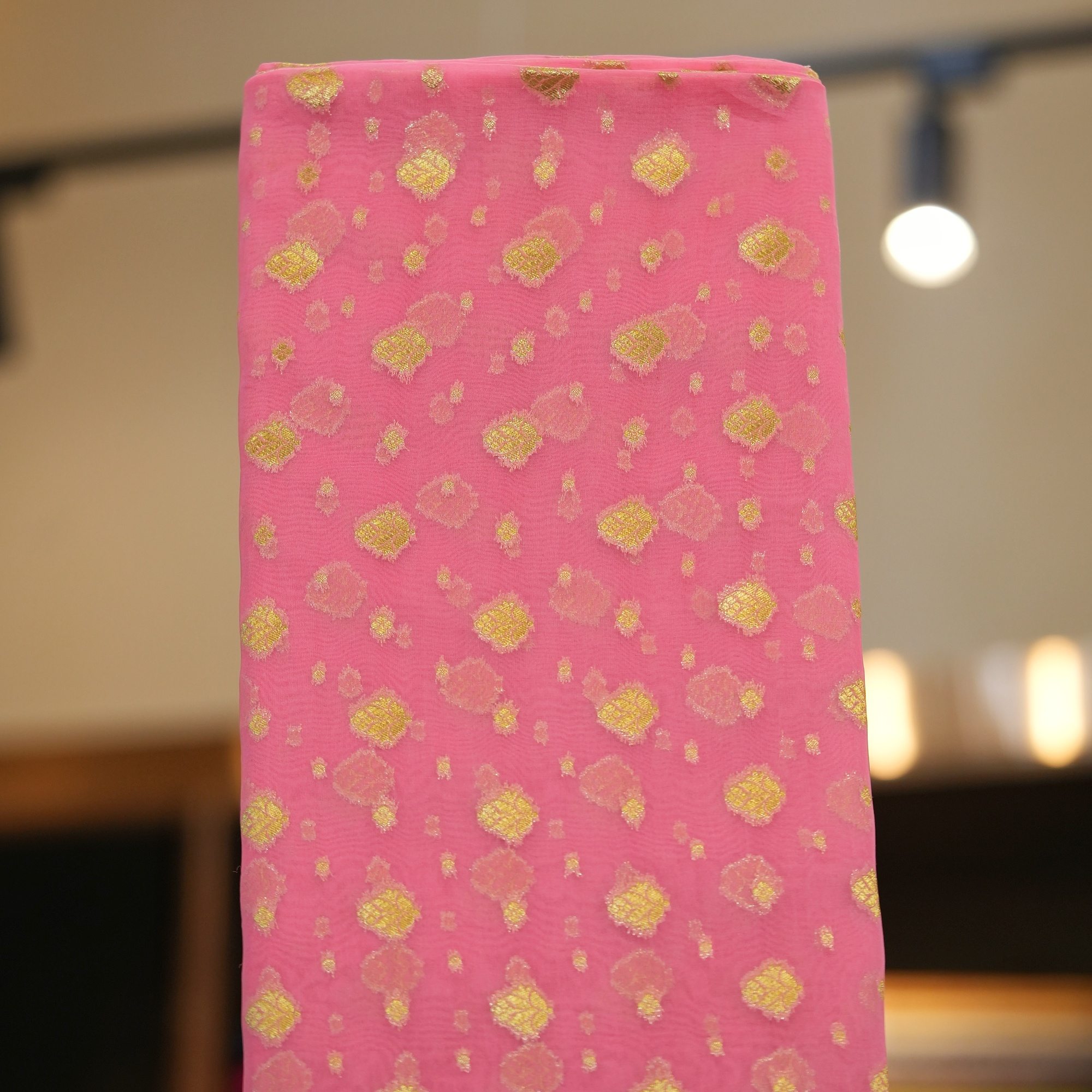 Elegant pink pure organza fabric with golden zari woven floral butas