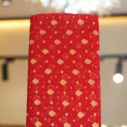 Rich red pure organza fabric with golden zari woven leaf motifs
