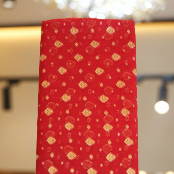 Rich red pure organza fabric with golden zari woven leaf motifs