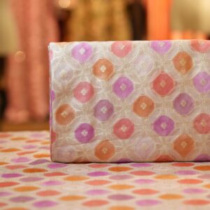 Katan silk fabric with octagonal Zari weaving and multicolor rangkaat dye in pink, orange, and lavender