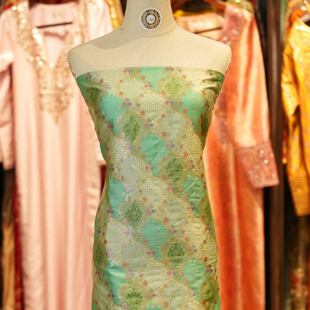 Mint green cotton jacquard fabric with golden Zari geometric weave and delicate printed florals – Firdaws-e-Zar