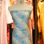Elegant blue cotton jacquard fabric with Zari geometric weave and printed floral accents – Firdaws-e-Zar