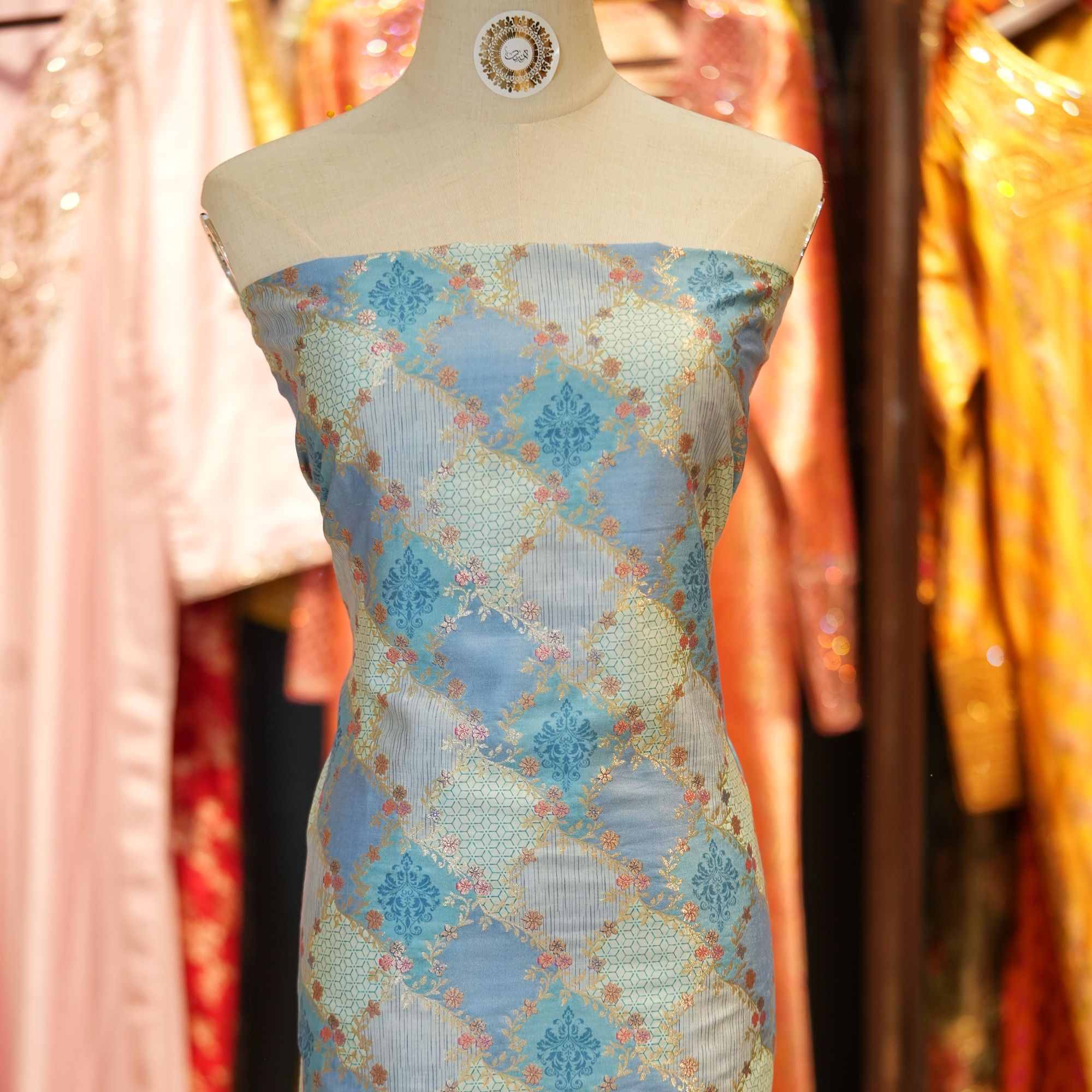 Elegant blue cotton jacquard fabric with Zari geometric weave and printed floral accents – Firdaws-e-Zar