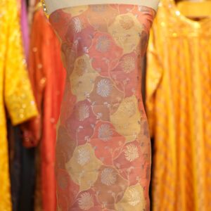 • Material: 100% Pure Silk • Weaving: Handwoven with Silver Zari • Dye Style: Traditional Rangkaat Dye Technique • Motif: Floral vines and blooming buta • Width: Approx. 44–45 inches • Color Palette: Dual-toned Rangkaat shades of peach, golden yellow, and saffron • Feel: Smooth, glossy finish with soft hand feel • Recommended For: Emirati thobes, kaftans, sarees, formalwear • Care Instructions: Dry clean only. Store wrapped in breathable cloth away from direct light.